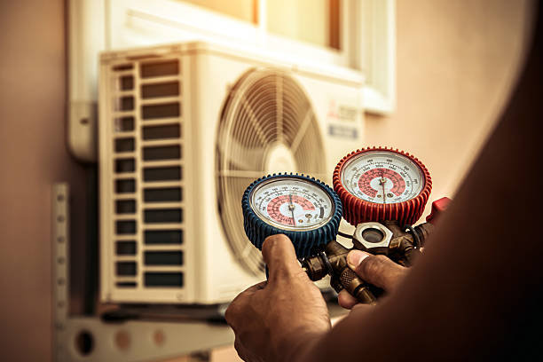 Professional Air Conditioning Service technician working in Clinton, IA